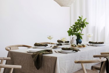 dining table with neutral linens and place settings