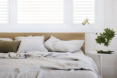 bed with Cultiver linens on bed with wood headboard