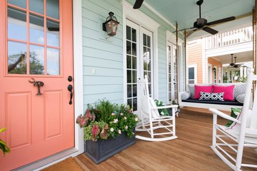 Seafoam green exterior house paint with front porch decor and salmon front door