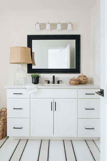 Striped tile coastal flooring idea in bathroom with white vanity