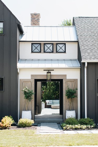 white and black exterior modern farmhouse with sliding barn doors