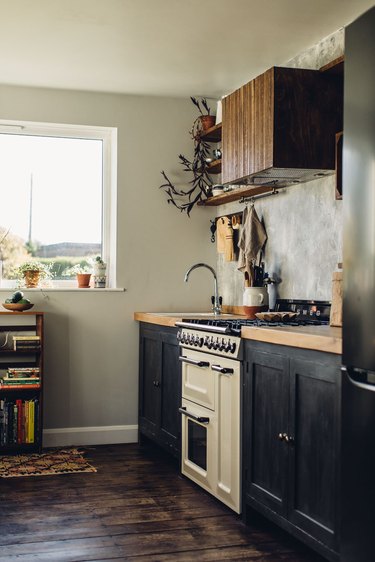 rustic kitchen with white retro stove and dark cabinets