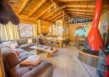 Rustic cabin with red Swedish fireplace