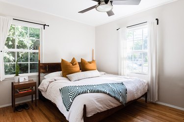 Bed with yellow pillows and patterned blanket