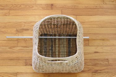 Steel rod inserted through basket