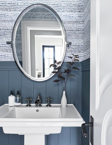 traditional vitreous china pedestal bathroom sink in front of blue walls
