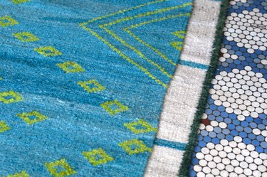 colorful patterned textiles on mosaic tile floor