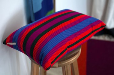 colorful striped pillow on wood stool