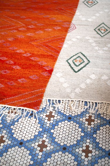 colorful patterned textiles on mosaic tile floor