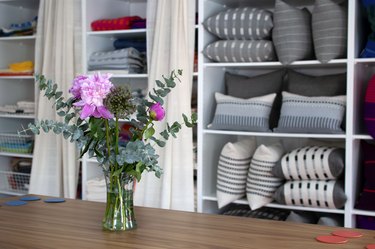 built-in bookcase filled with textiles and pillows