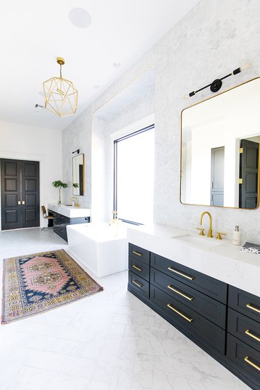 bathroom with his and hers black vanity cabinets