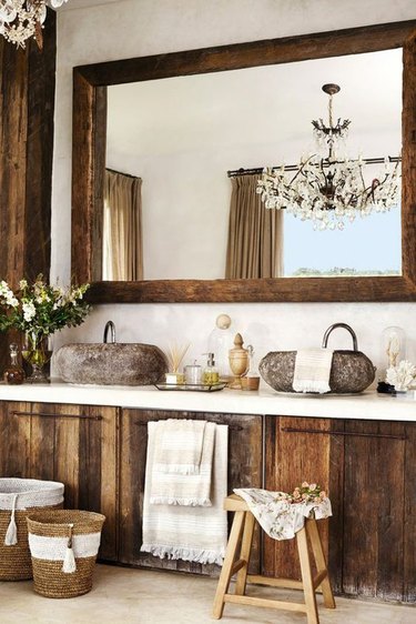 Bathroom with rustic wood mirror and cabinetry