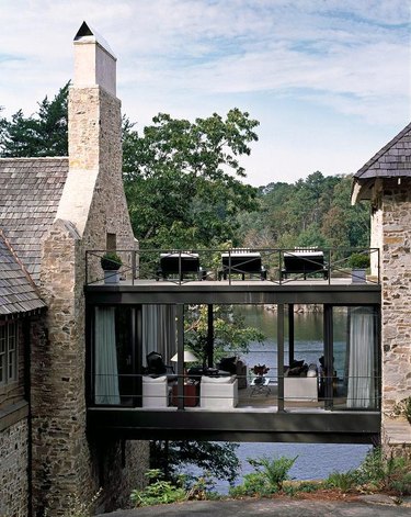 Stone Exterior Homes on Stone lake house with glass skyway by Andrew Brown Interiors