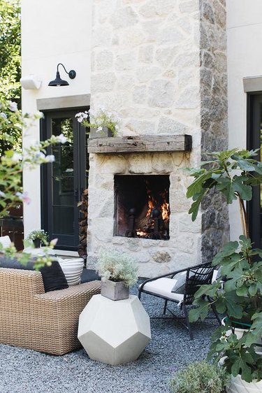 Stone Exterior Homes with Outdoor stone fireplace by Grand Tradition Homes