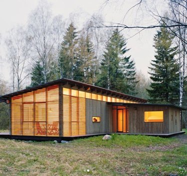 wood and glass cabin with addition of horizontal wood slats