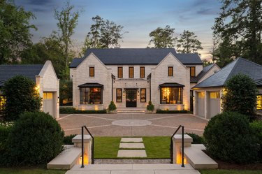 Stone Exterior Homes with stone garage and driveway by TS Adams Studio