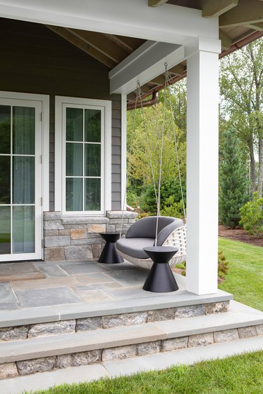 Stone Exterior Homes with Stone back patio by Chango & Co.