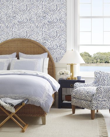 fern-patterned wallpaper and chair in coastal bedroom