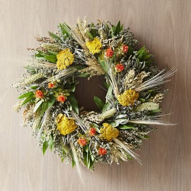 fall flower arrangement orange yellow and green wreath