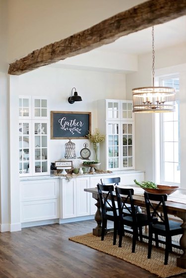rustic dining room with wood ceiling beam and wood flooring