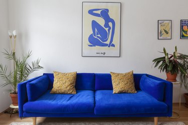 royal blue couch with gold pillows