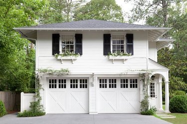 white house exterior with carriage style garage doors