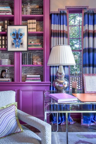 Red-violet tertiary color library with striped curtains and blue decor