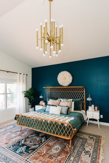 Blue-green tertiary color accent wall in a modern bohemian bedroom