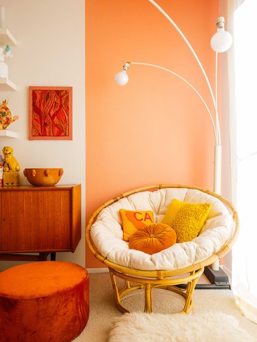 reading nook with orange accent wall and midcentury decor