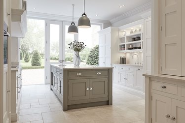 limestone kitchen flooring with white cabinets and gray island