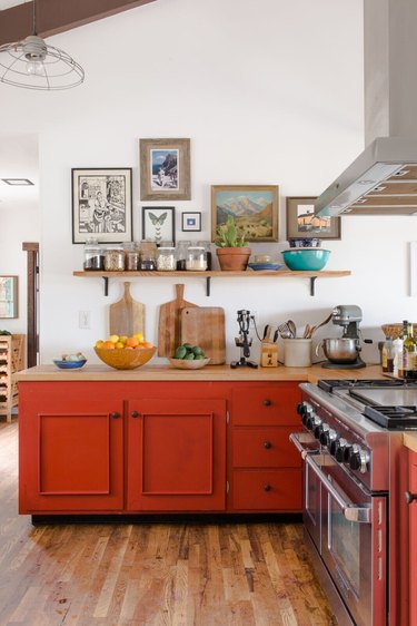 Red-orange tertiary color cabinets in a vintage-inspired kitchen