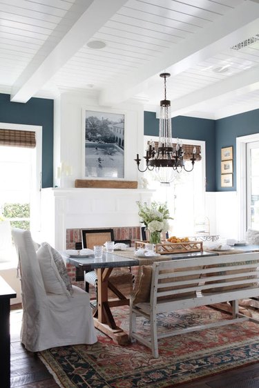 rustic dining room with white wainscoting and blue walls