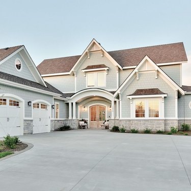 blue gray exterior paint with double doors and large driveway