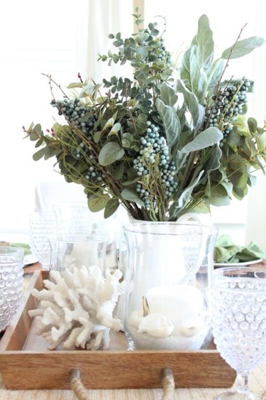 Coastal fall decor with centerpiece with fall florals and white seashells