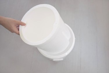 Inserting styrofoam bucket liner insider plastic bucket
