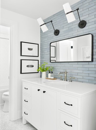 Sky blue subway tile coastal backsplash in white guest bathroom