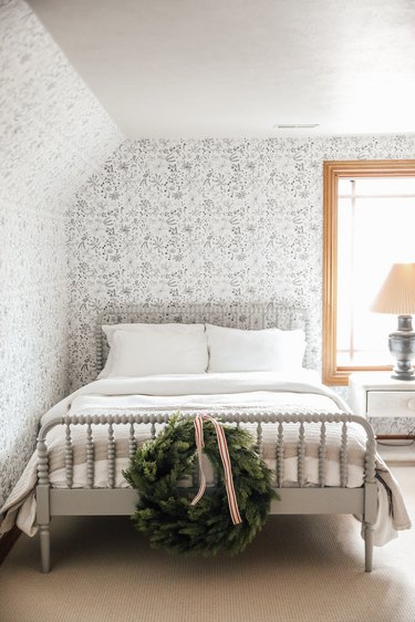 white finished attic idea for bedroom with whimsical wallpaper and bed