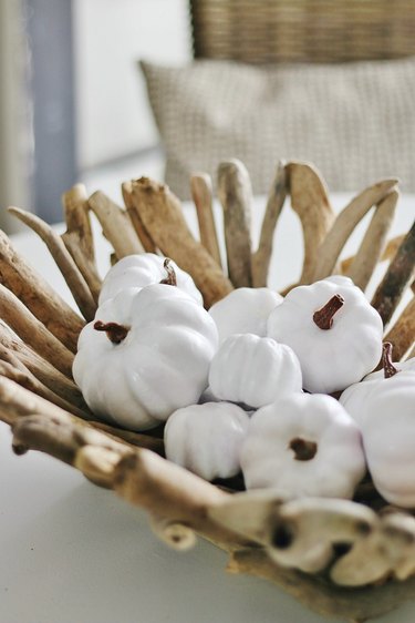 Coastal fall decor with driftwood bowl with white pumpkins