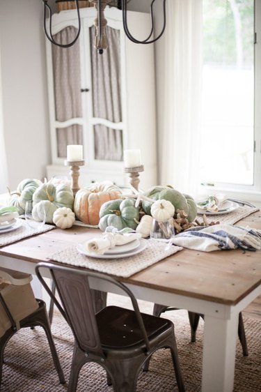 Coastal fall decor tablescape with pumpkins and starfish