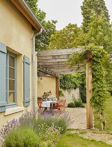 French country exterior with colorful shutters
