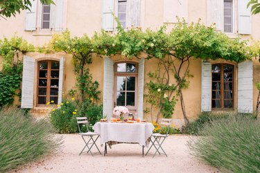 soft orange French country exterior with table set out front