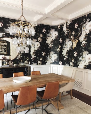 dining room with floral wallpaper and rustic dining table