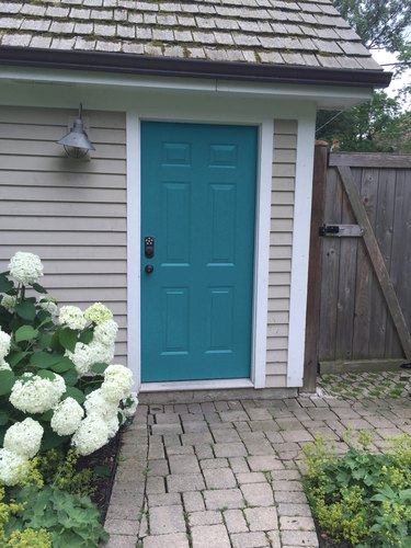 teal front door on gray house