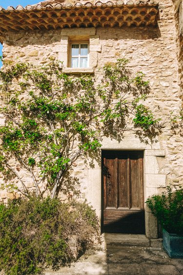 French country exterior made of stone with wooden door