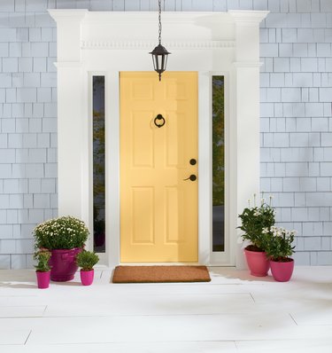 yellow front door on light blue house