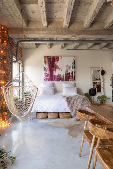 industrial bedroom with exposed concrete ceiling beams