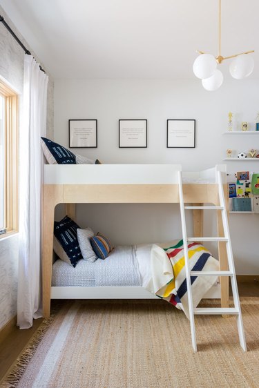 kids bedroom with bunkbeds and brass chandelier