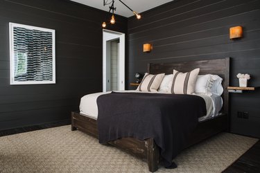 industrial bedroom with black shiplap walls