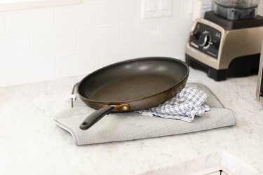 Frying pan on kitchen counter.