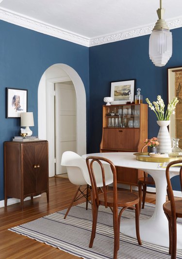 blue dining room with walnut furniture